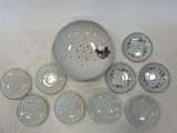 a lot of plates and bowls sitting on a table