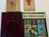 three books on a white table with a red book and a brown book