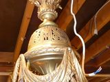 a large gold chandelier hanging from the ceiling in a room