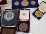 a lot of silver and gold coins in a case