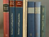 Plusieurs livres sont empilés les uns sur les autres sur une table.