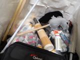 a black bag with various items in it sitting on the floor