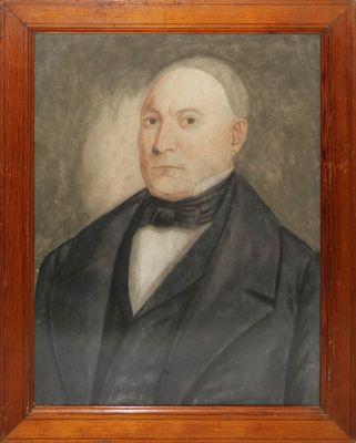 portrait of a man in a suit and bow tie in a wooden frame