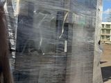 a man that is standing next to a pallet full of boxes
