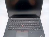 the laptop is open on a white surface with a black keyboard