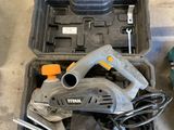 two tools that are sitting on the floor next to each other