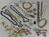 many different types of necklaces and bracelets on the table