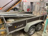 a trailer with a trailer attached to it in a garage