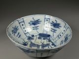 blue and white bowl with oriental design on the rim