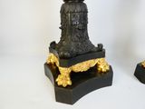 two black and gold vases with flowers on them