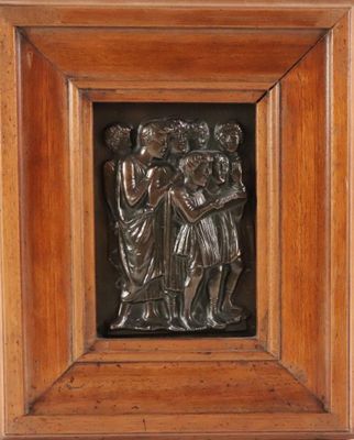 a close up of a metal plaque in a wooden frame