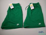 a pair of green nike shorts with tags on them