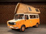an orange van with a tent on top of it