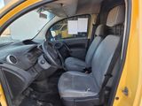 a yellow truck with a black seat in the back of it
