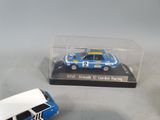 two toy cars in a display case on a table