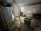 a small kitchen with a refrigerator and a microwave in it