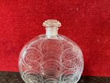 an image of a glass bottle on a table with a red background