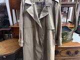an image of a coat is hanging on a dresser in a room