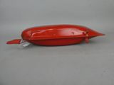 an image of a red plastic object with a tag on it
