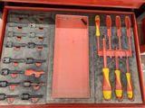 a red box with tools in it on a table