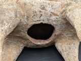 a close up view of a stone vase with a hole in it