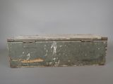 an old wooden box with a metal lid sitting on top of a table