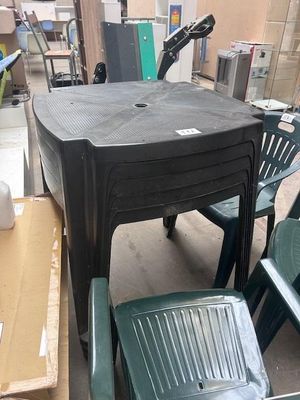 a table and chairs in a room with a lot of boxes