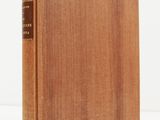 a wooden book sitting on top of a white surface