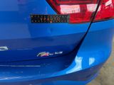 a close up of a blue car with a sticker on it