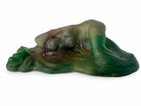 a figurine of a woman laying down on the ground