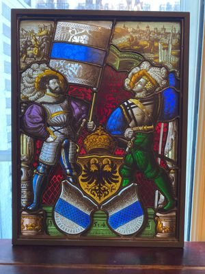 a picture of a stained glass picture of two knights and a shield