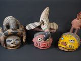 several different types of masks are displayed on a black surface