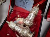 two silver vases in a red box on a table