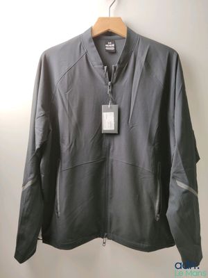 a close up of a jacket hanging on a hanger on a wall