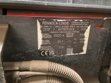a close up of a machine with a hose attached to it ' s side