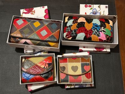 three boxes with different types of purses are sitting on a table