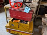a red wheel on a yellow cart in a garage