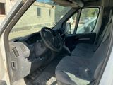 the interior of a white van with the door open and the driver ' s seat down