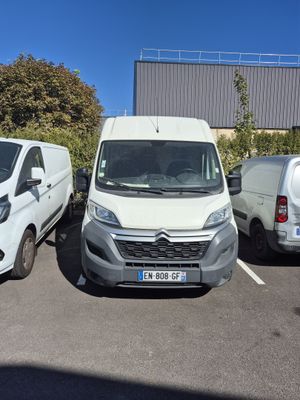 two vans parked in a parking lot next to each other