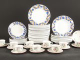 un grand nombre d'assiettes et de tasses posées sur une table