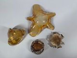 three pieces of glass sitting on a white surface