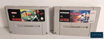 two nintendo game cartridges sitting next to each other on a table