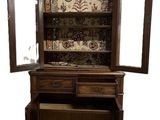 a wooden cabinet with a mirror on top of it