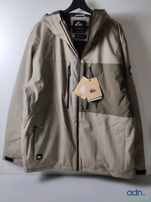 the jacket is hanging on a hanger on the wall