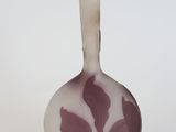 a purple vase with a floral design on it
