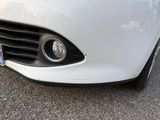 a close up of a white car with a license plate on it