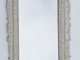 a mirror hanging on the wall in a room