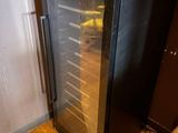 a wine cooler sitting in the corner of a room
