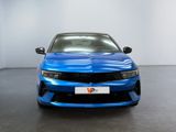 the front view of a blue car in a white room