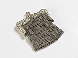 an image of a silver purse with a chain around it